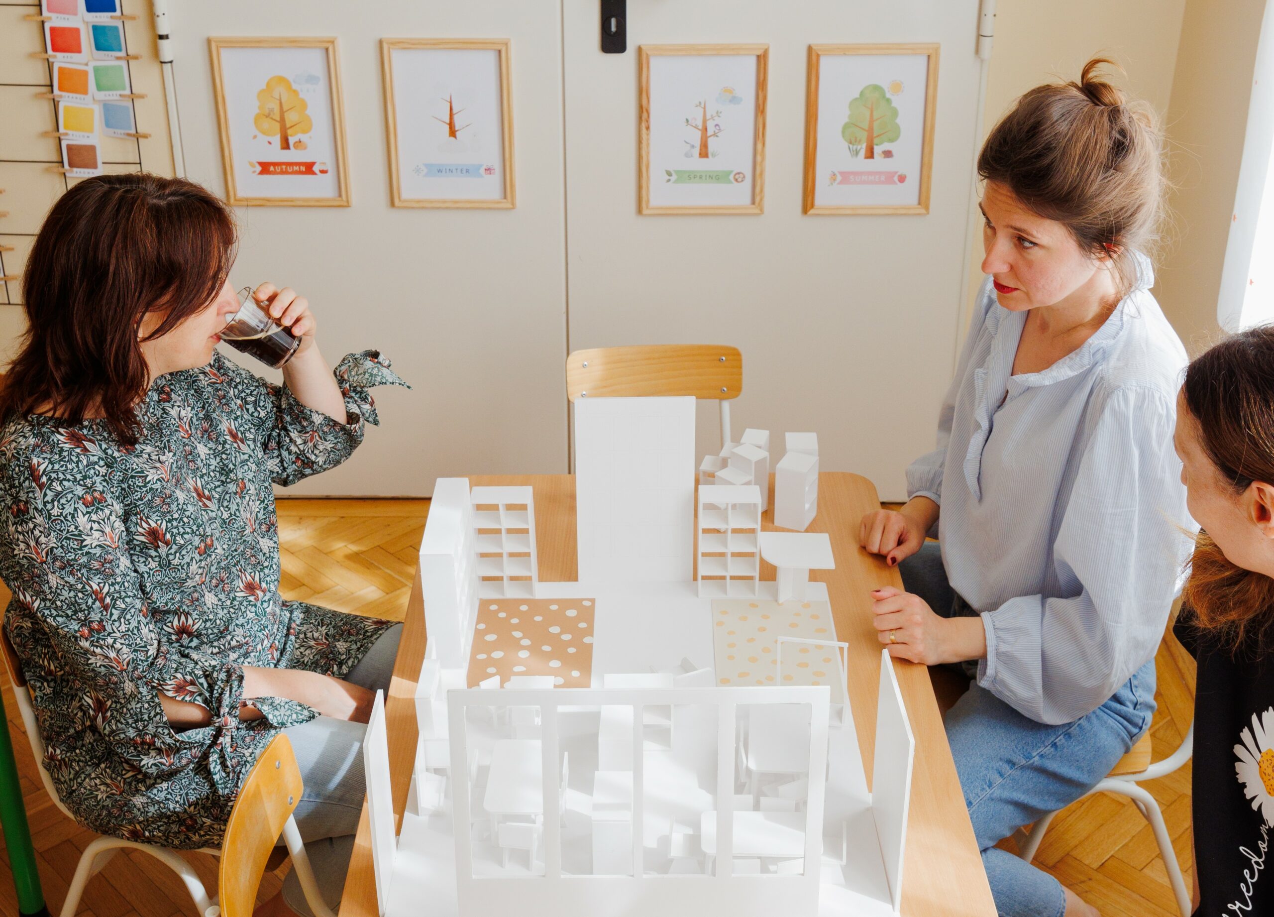 Three educators discussing a kindergarten classroom mock-up as part of a True Toys Classroom Enhancement Project