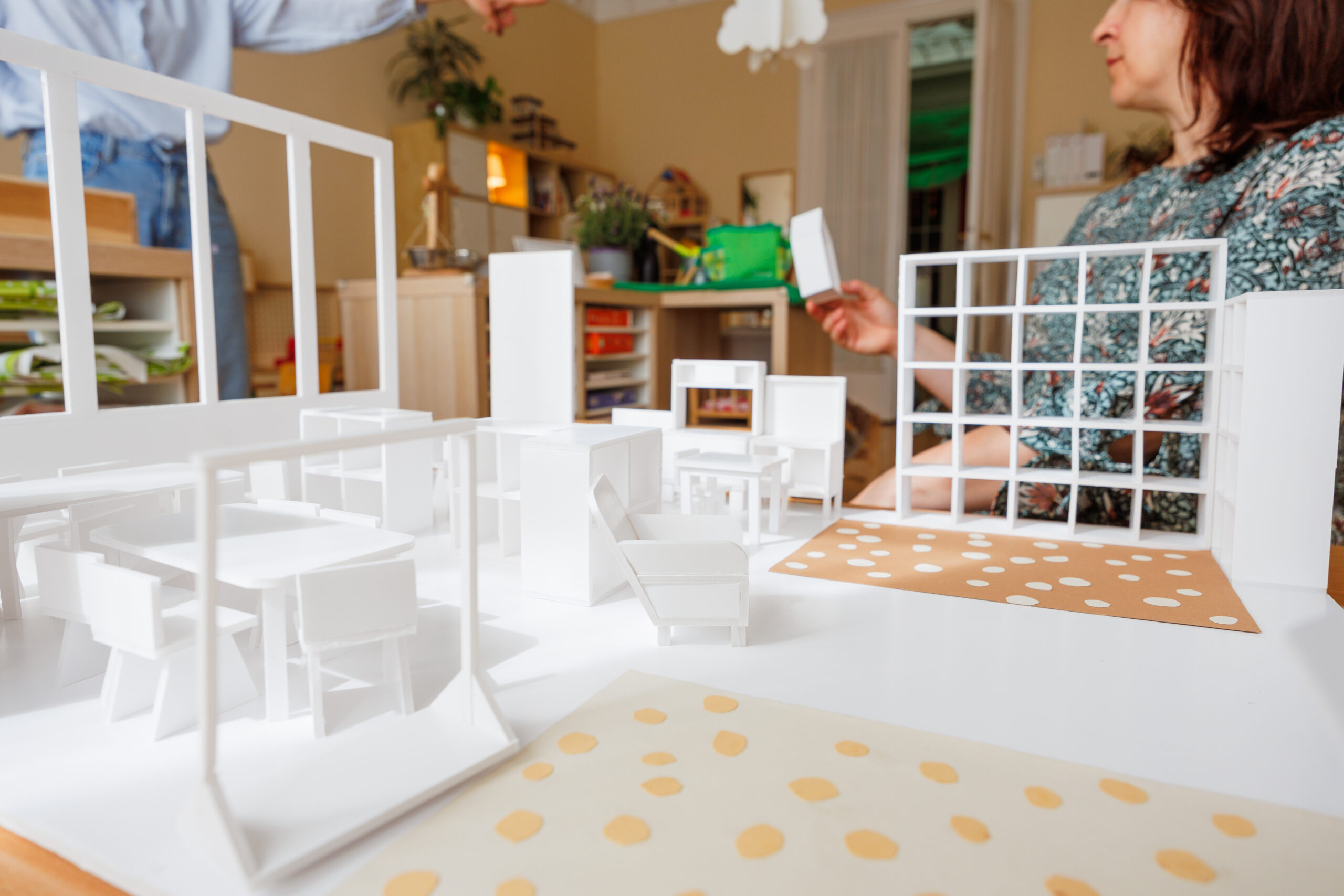 Two educators reviewing a kindergarten classroom mock-up, planning furniture arrangement as part of a True Toys enhancement project