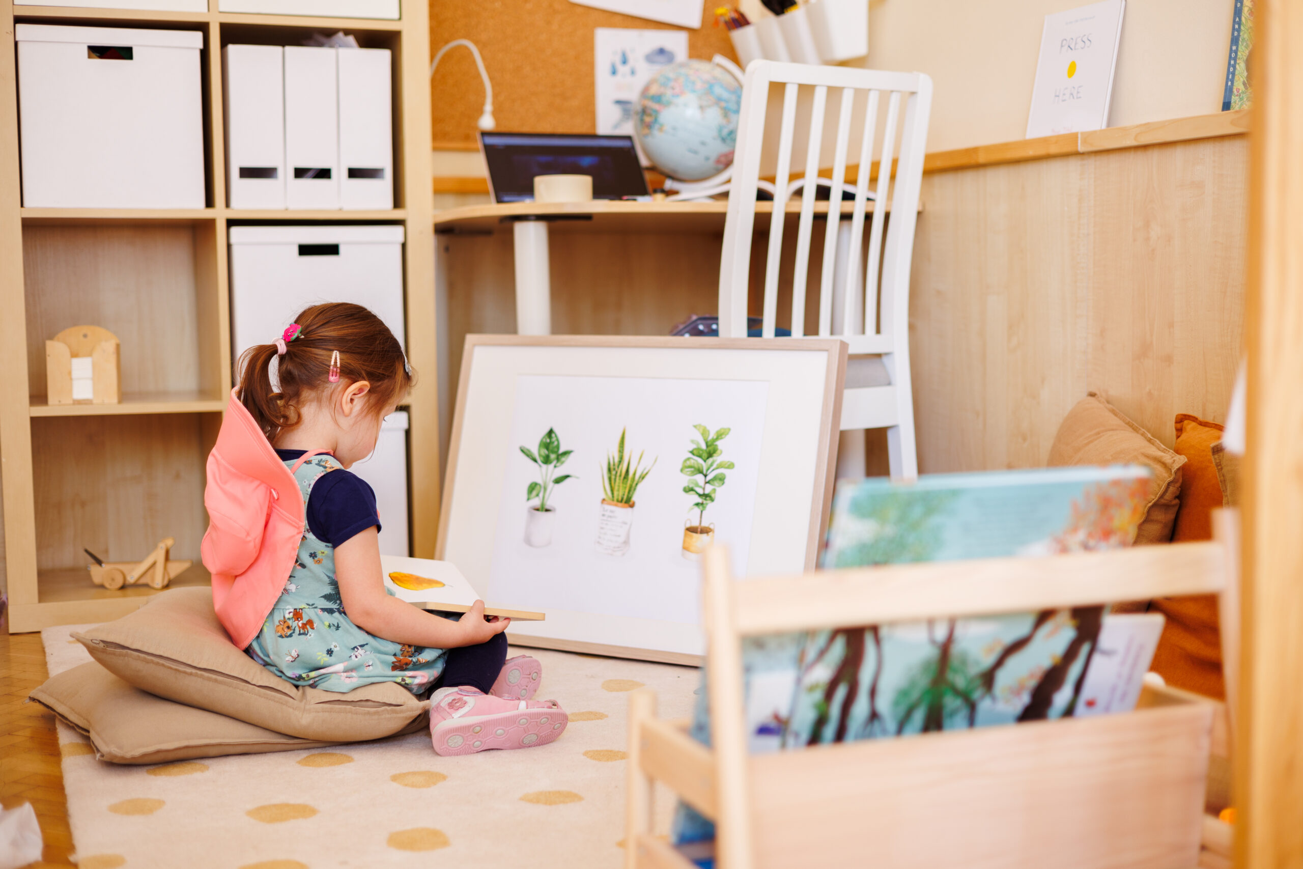 Cozy kindergarten reading corner with a child sitting on a pillow, reading a book at eye level, surrounded by toys and books